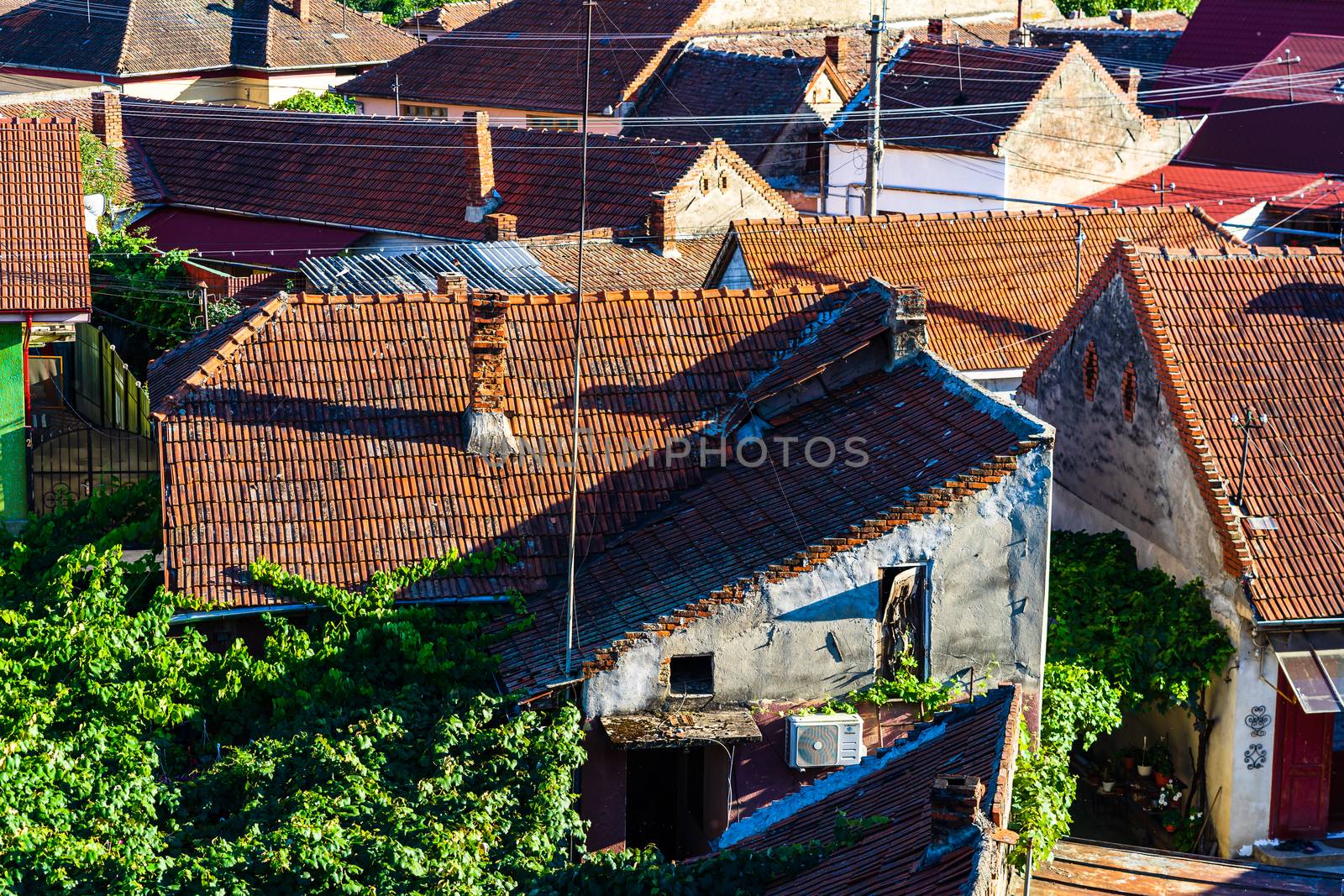 Overview of tile rooftops of old houses. Old buildings architect by vladispas