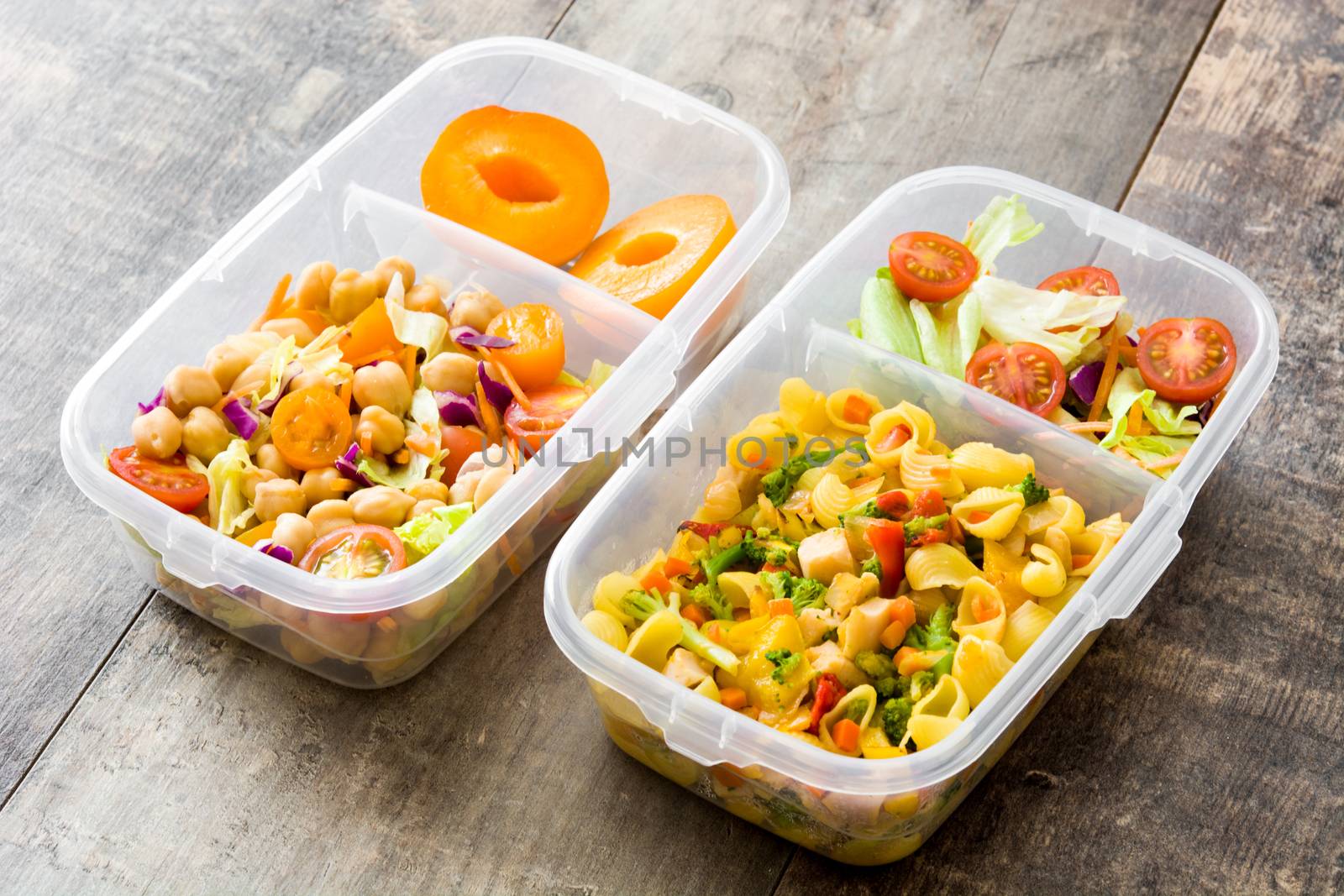 Lunch box with healthy food ready to eat on wooden table