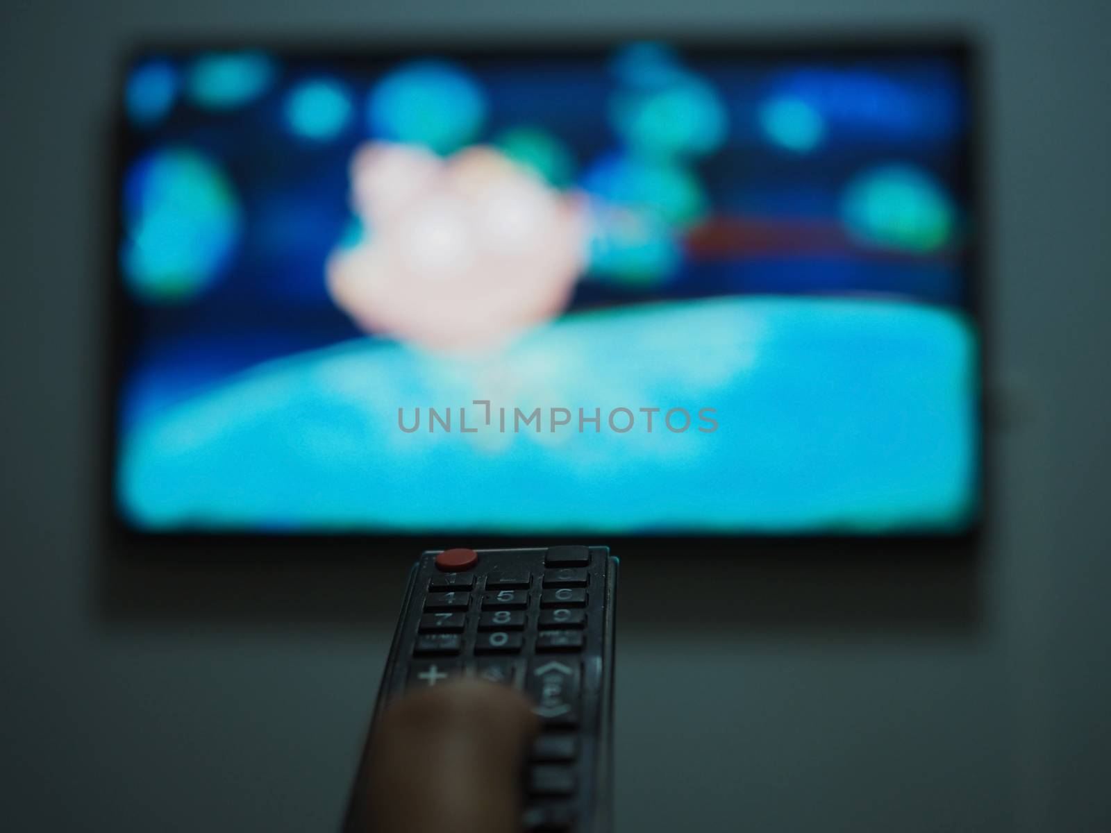 The remote control image on the TV background is out of focus. by Unimages2527