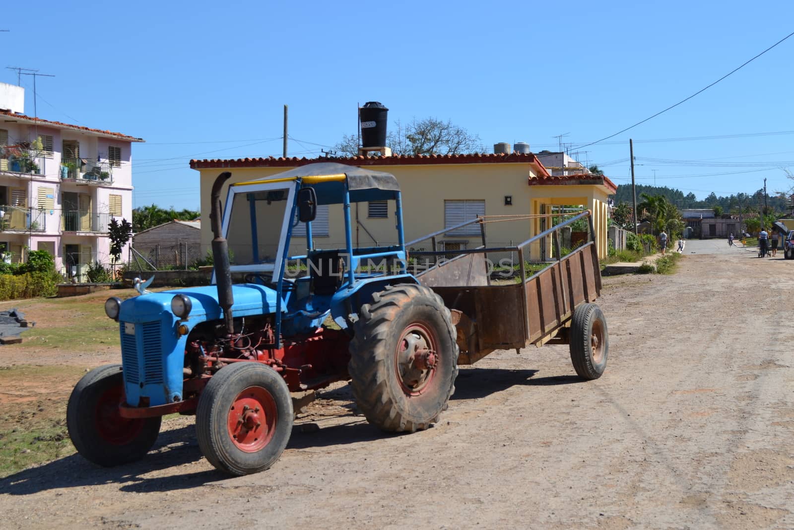 old and vintage blue tractor in the streets of Vinales, Cuba by kb79