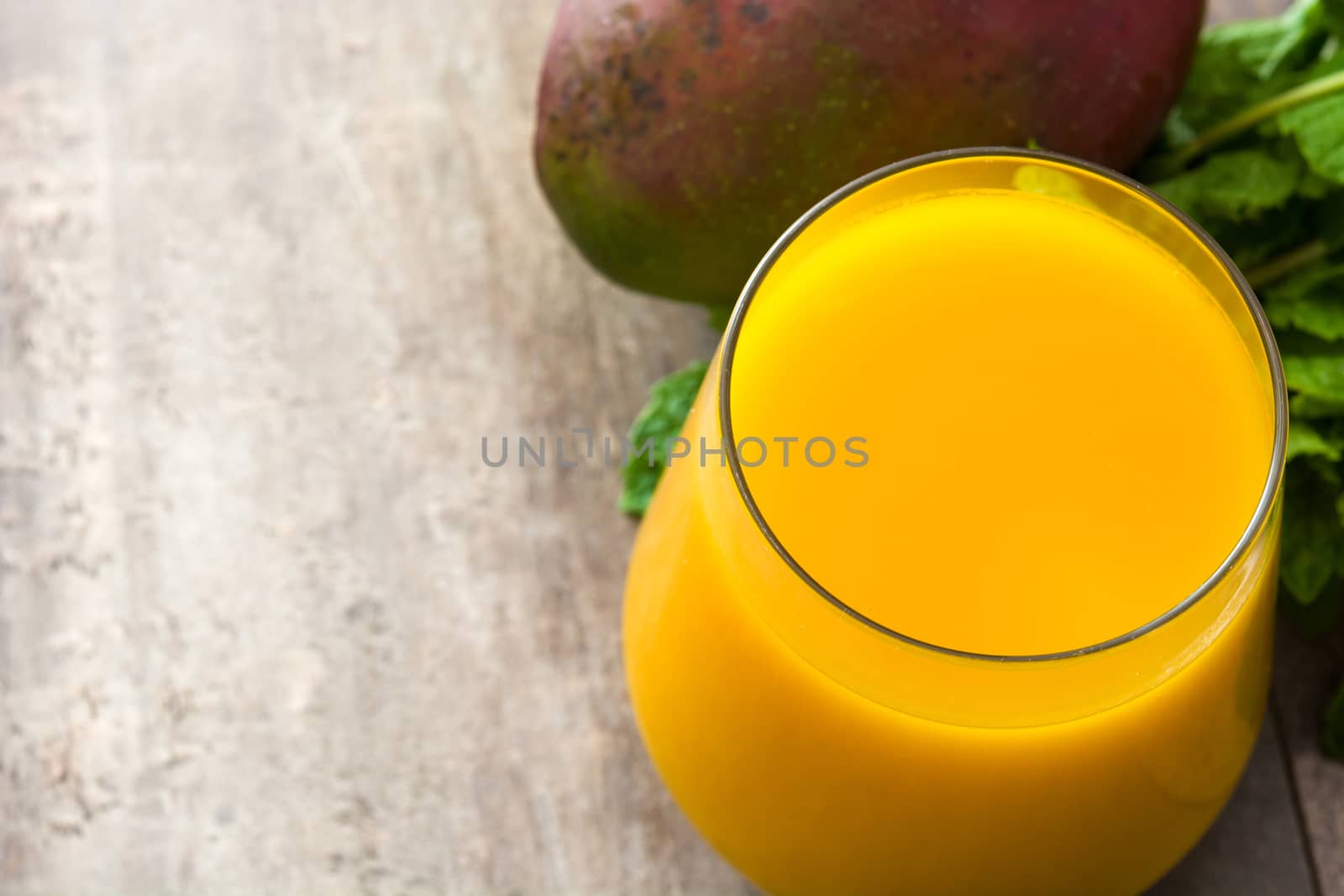 Mango Lassi dessert. Traditional Indian drink on wooden table. Copyspace