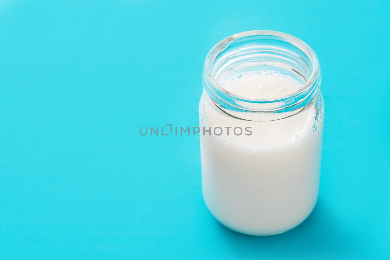 Milk glass on blue background.