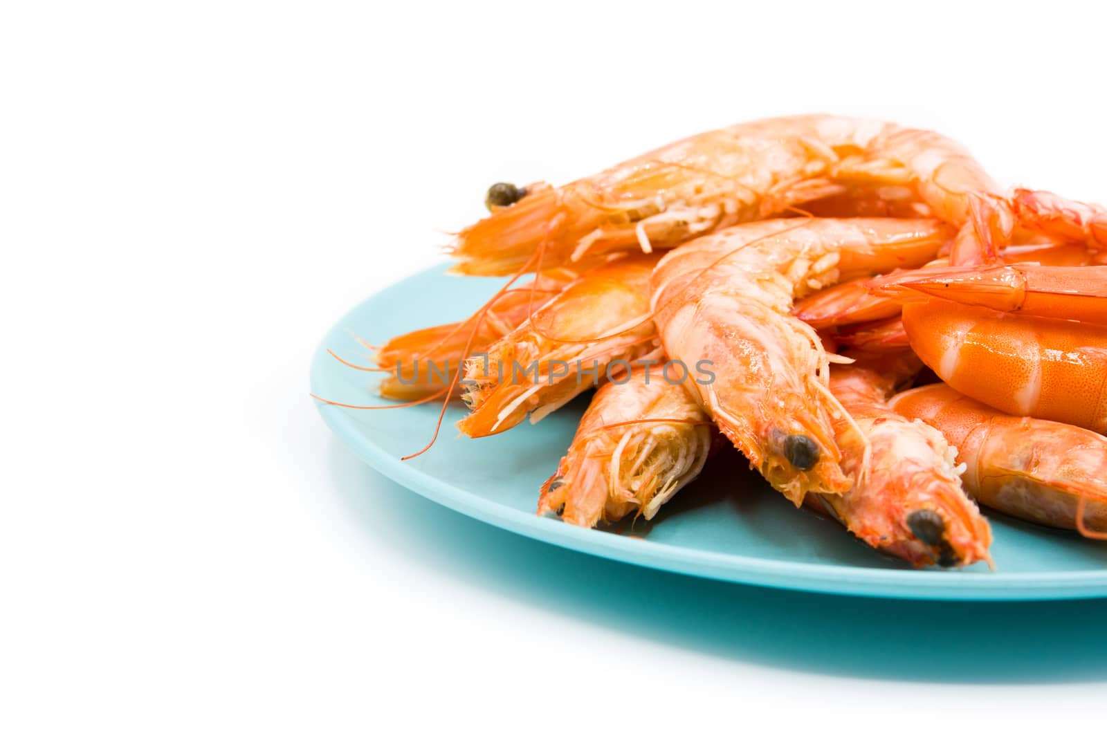 Grilled shrimps on blue plate isolated on white background
