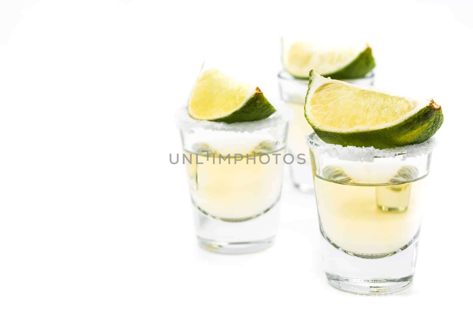 Mexican Gold tequila with lime and salt isolated on white background by chandlervid85