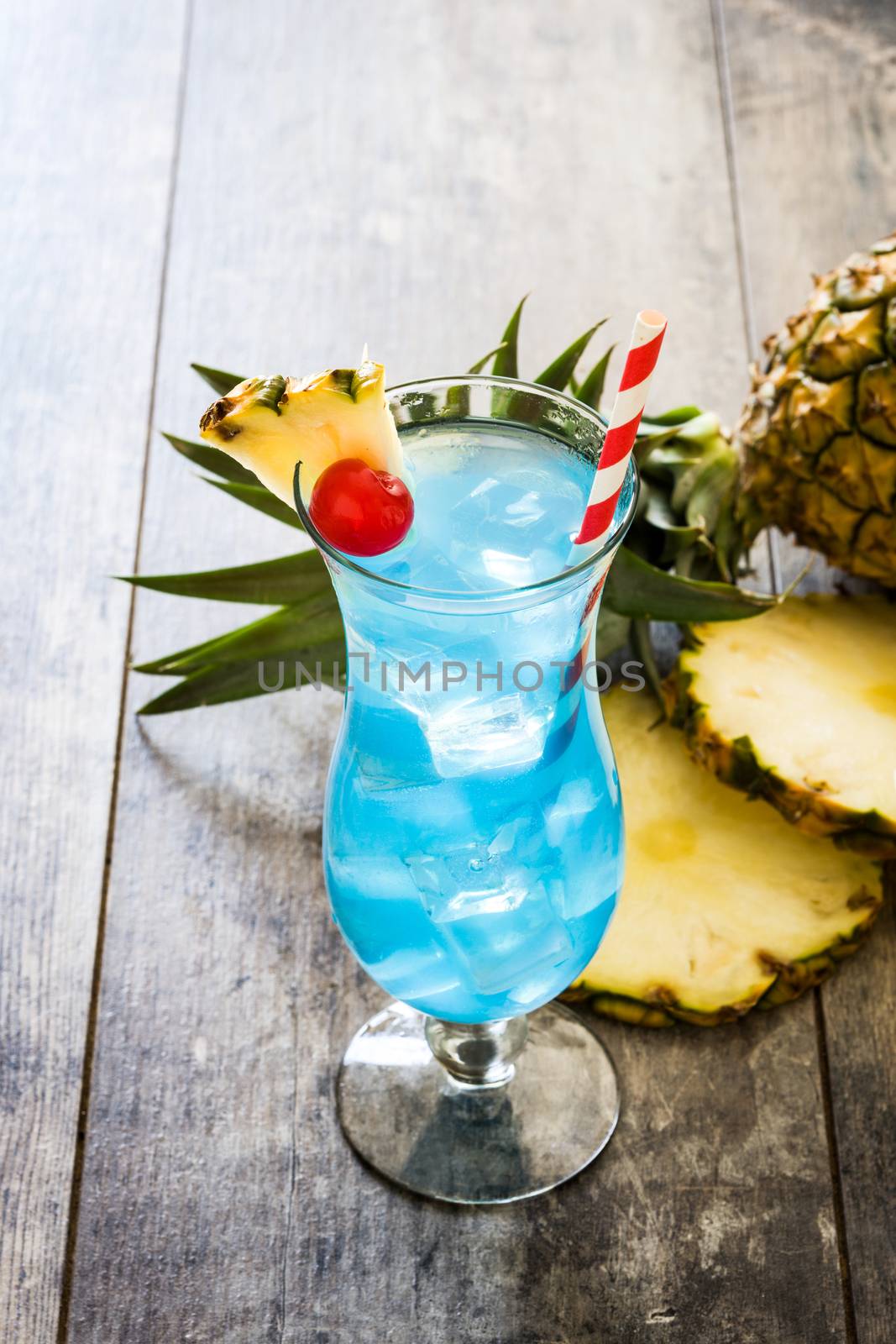 Blue Hawaiian cocktail on wooden table