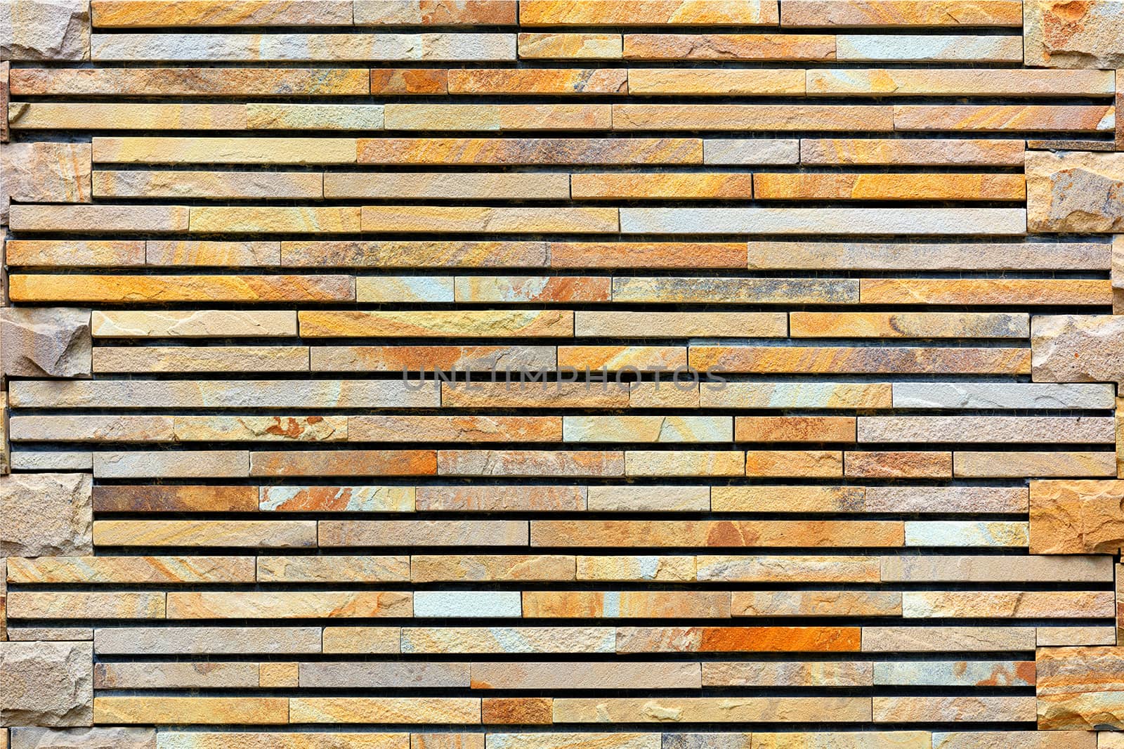 A stone wall made of pieces of machined flat golden sandstone. by Sergii