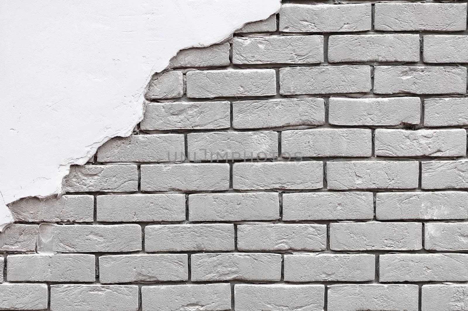 Texture of an old white brick wall with old stucco in the upper left corner. Background of silicate brick in the form of brick masonry, copy space.