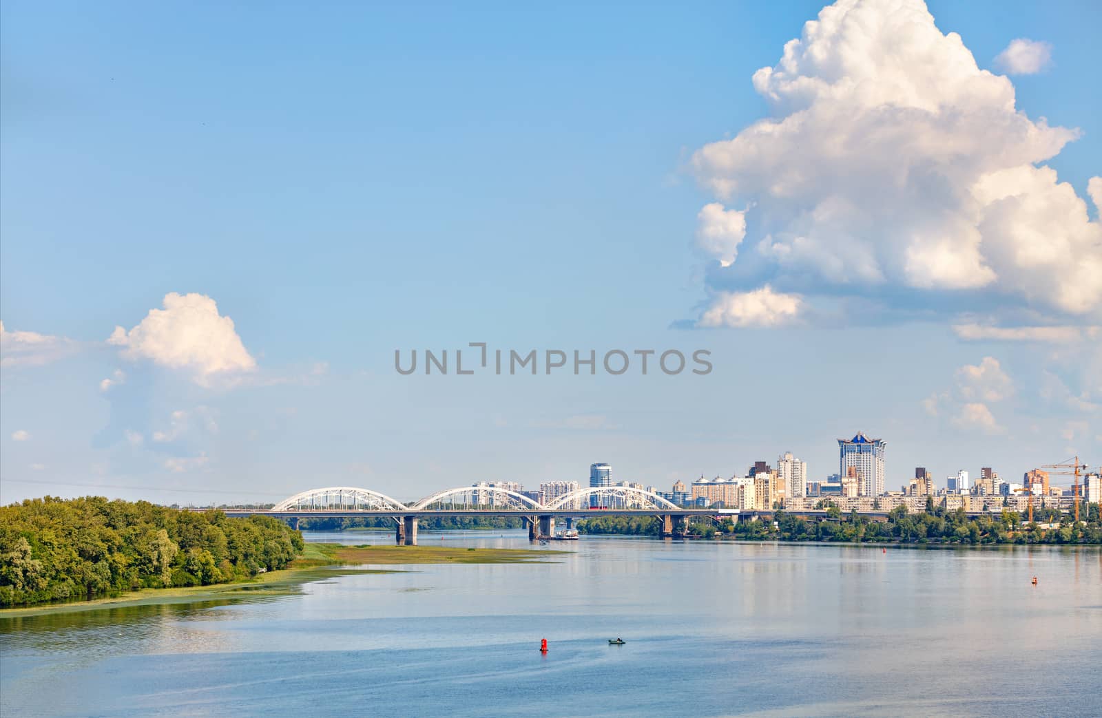 A large figured cloud hung over the city near the railway bridge near the Dnipro River. by Sergii