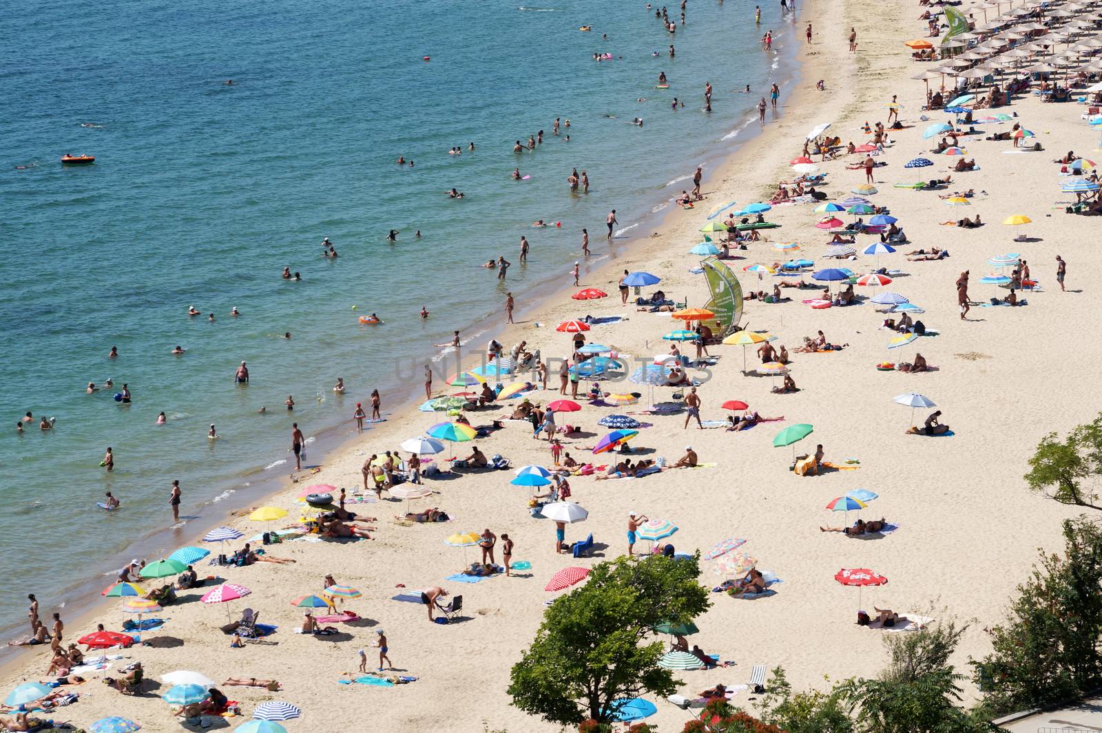 sea beach with tourists on sunny day, aerial photo by Annado