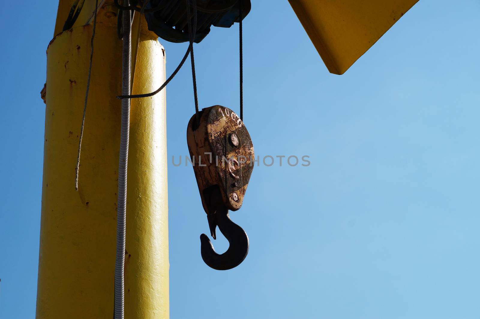 hook from the hoisting winch against the sky by Annado