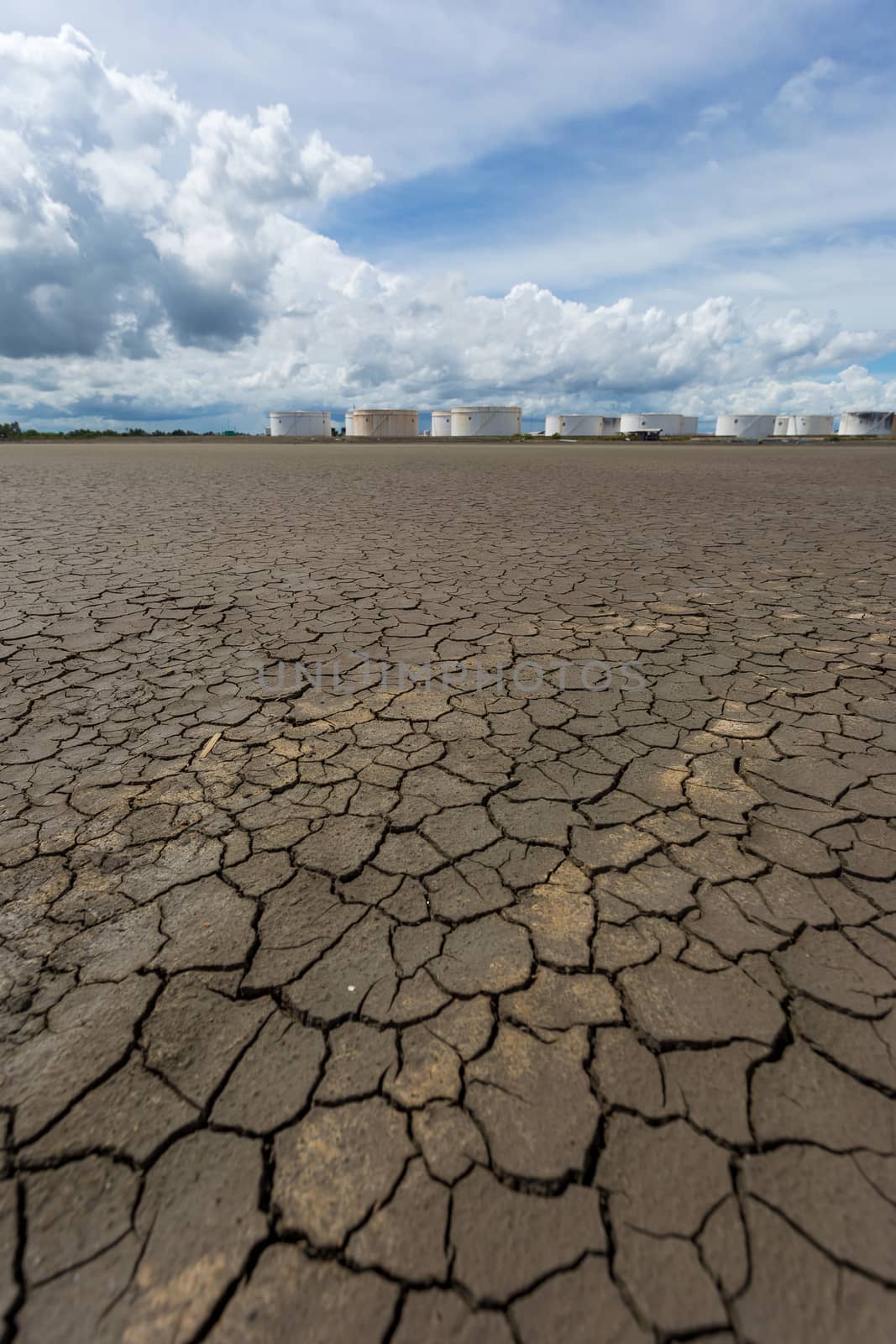 Global worming effect and Oil tanks in a row under blue sky by kaiskynet