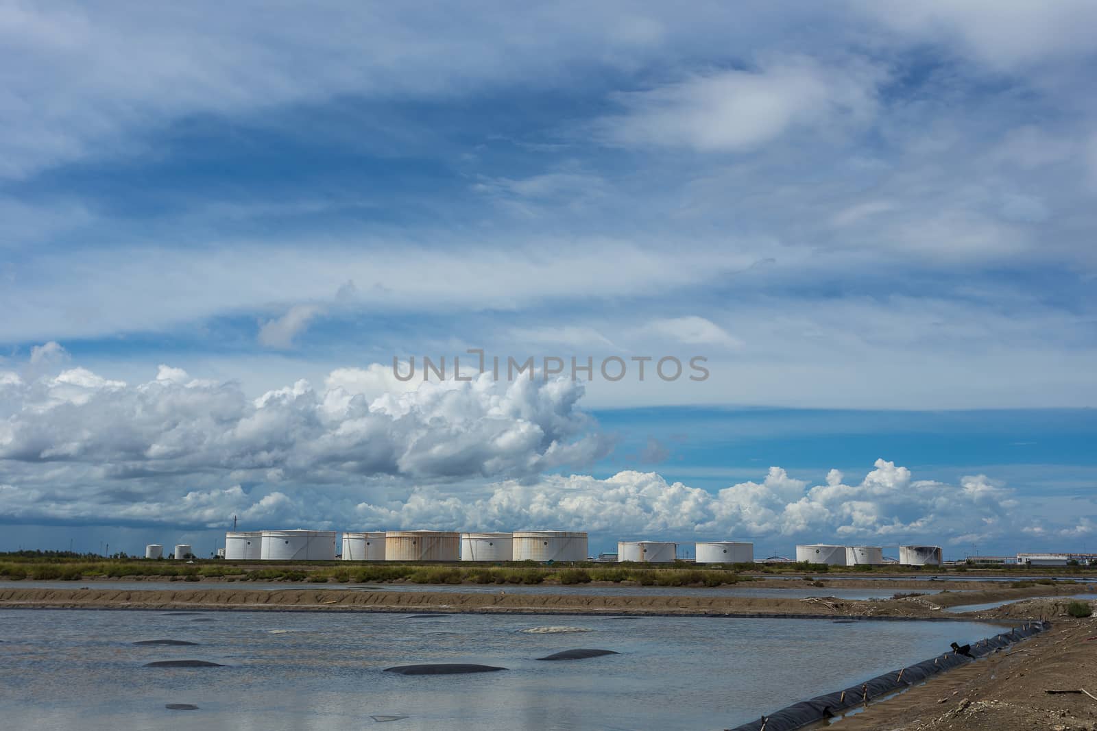 Oil tanks in a row under blue sky, Large white industrial tank for petrol, oil refinery plant. Energy and power.