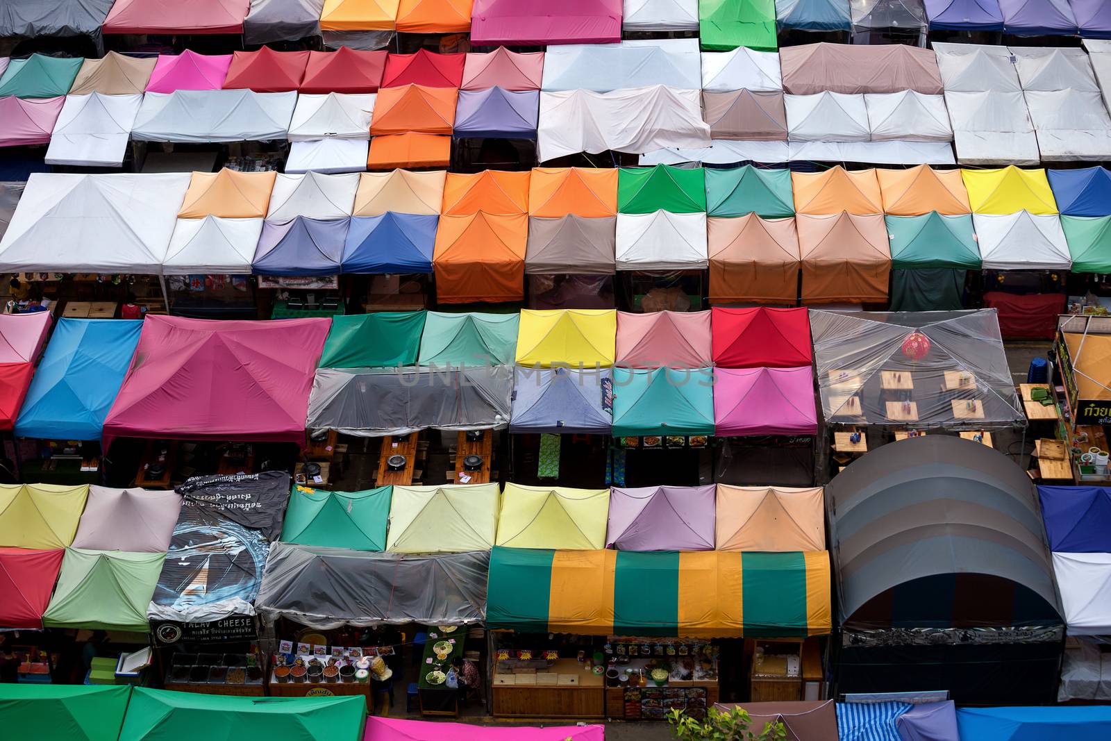 Colorful food stalls at Rod Fai Night Market in Bangkok.