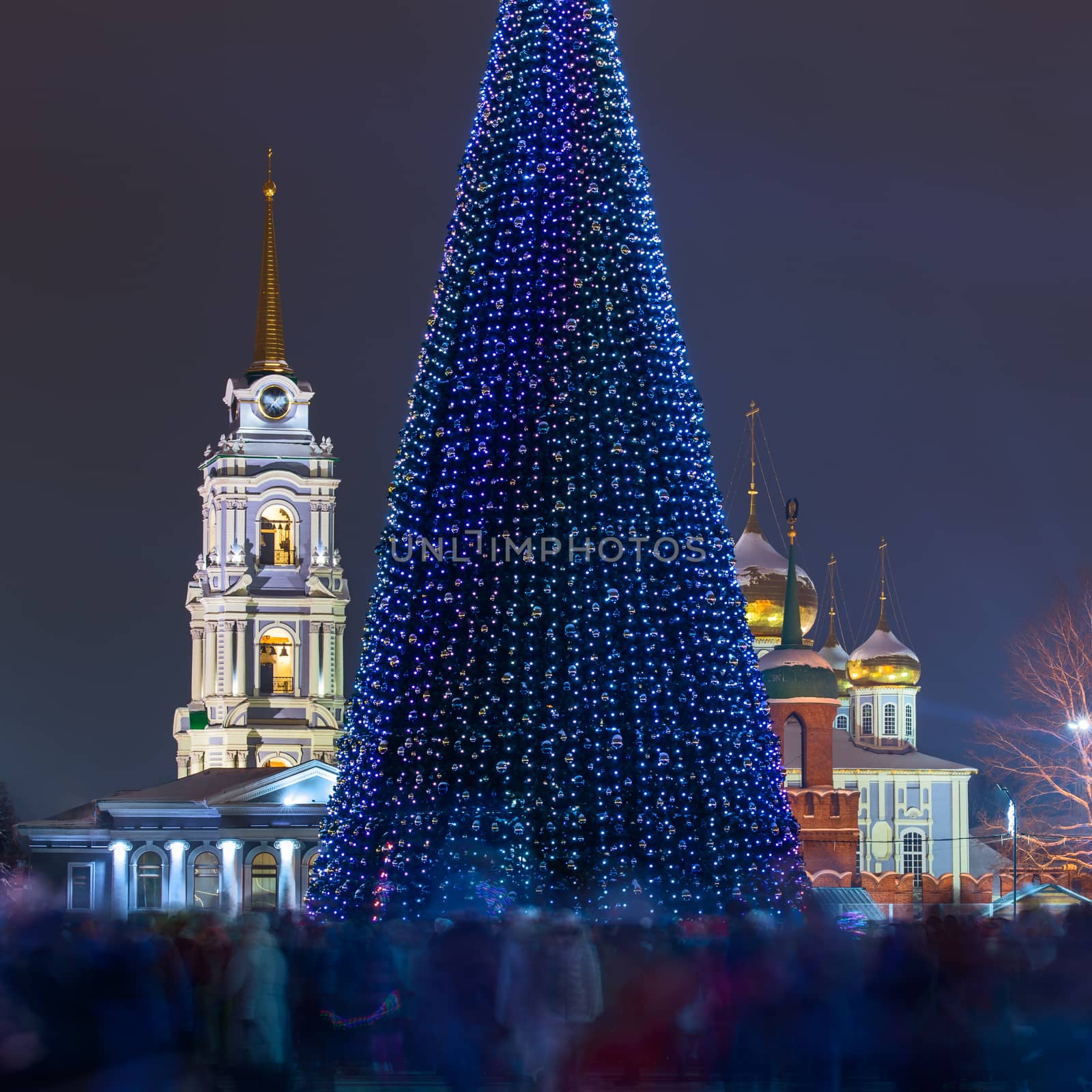 Christmas tree at night in central city square with crowd blurred by long exposure. Tula, Russia, 2018