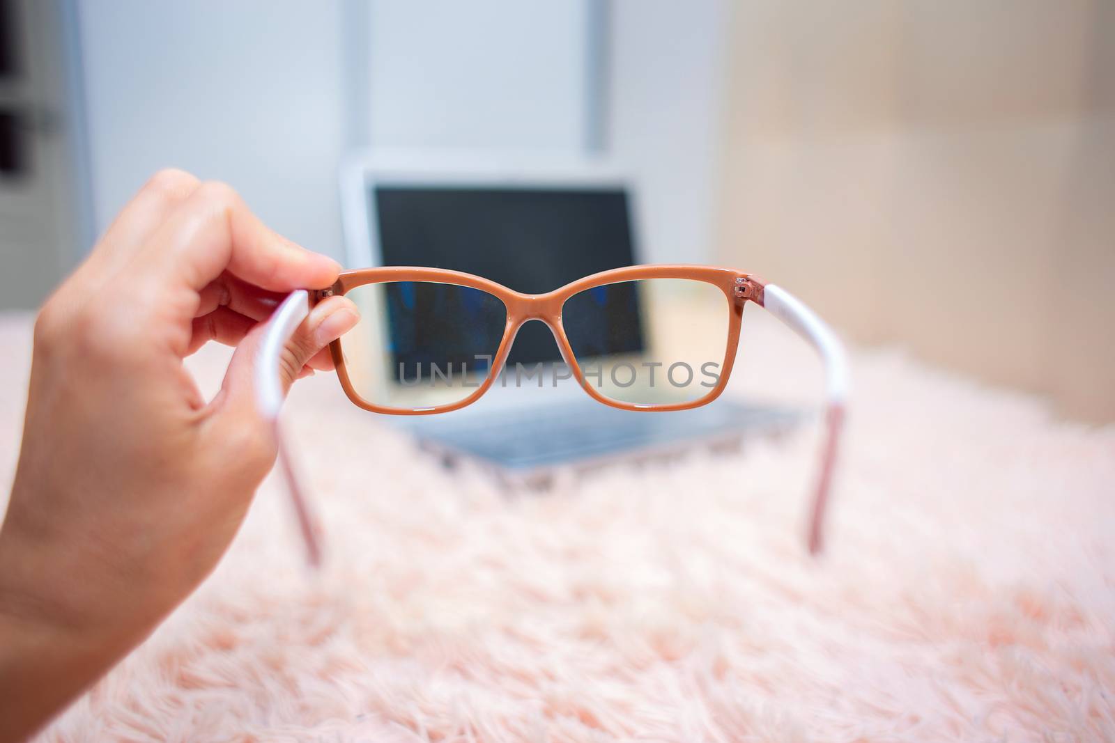 View of a laptop through special glasses for working on a computer. Eye protection from the influence of the monitor screen