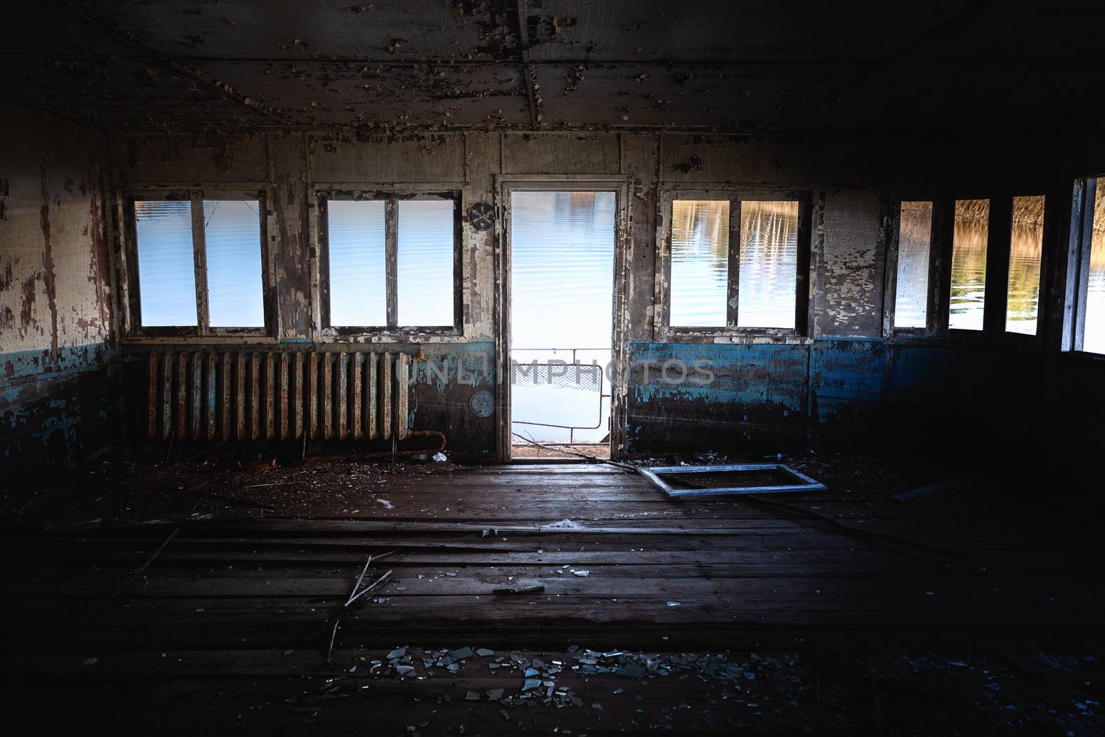 Dark room of abandoned boat lakeside angle shot