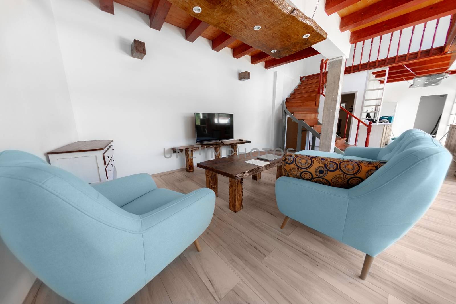 Living room with blue armchair and sofa angle shot