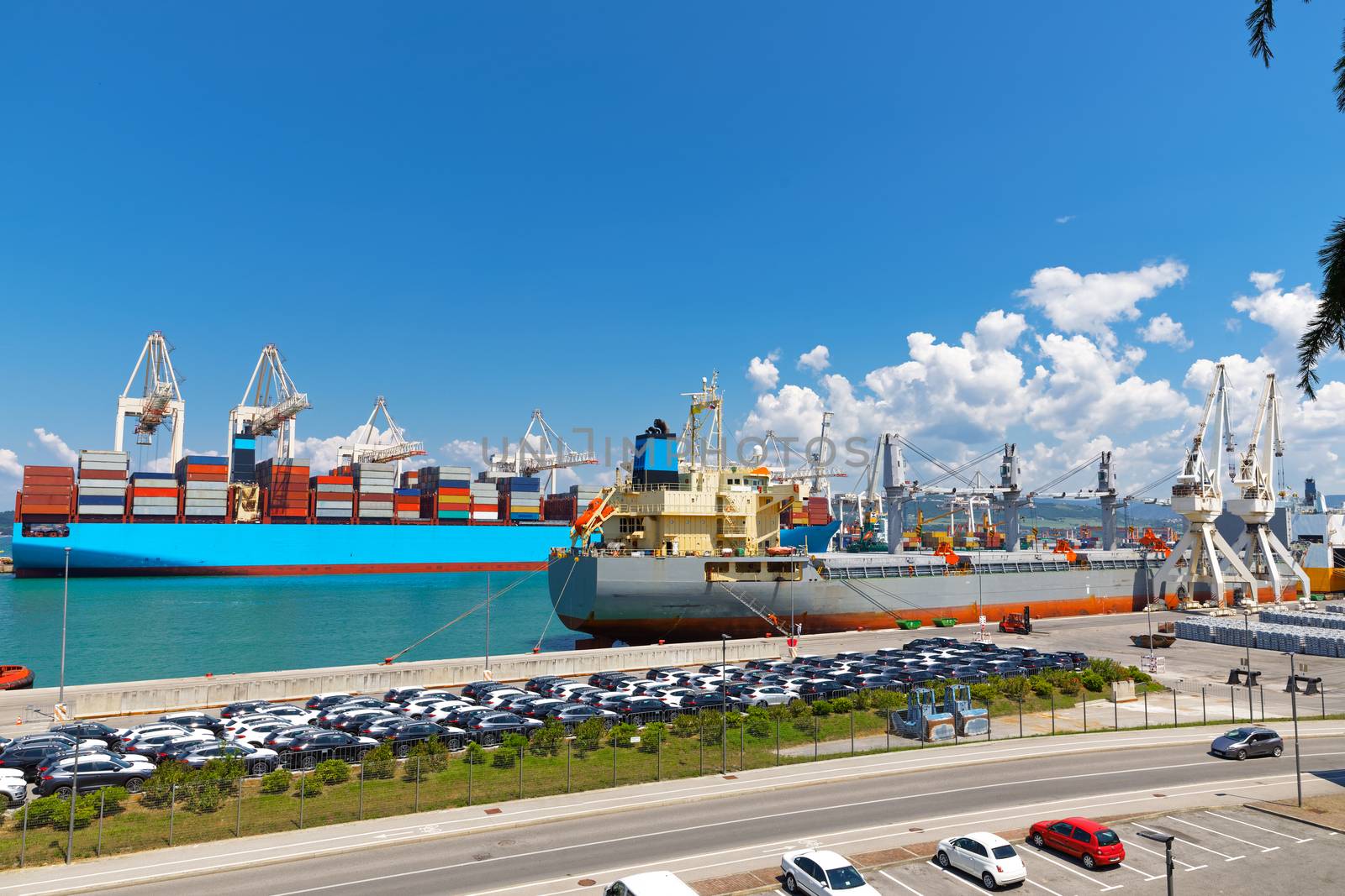 Large industrial port with many cranes and cargo containers