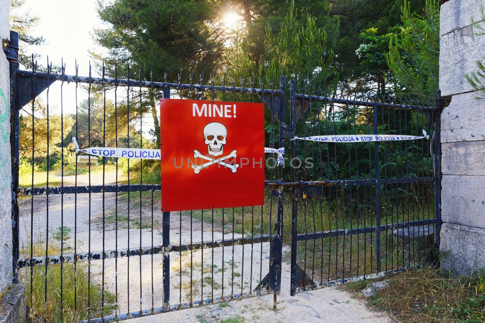 Beware of mines sign on closed territory closeup photo