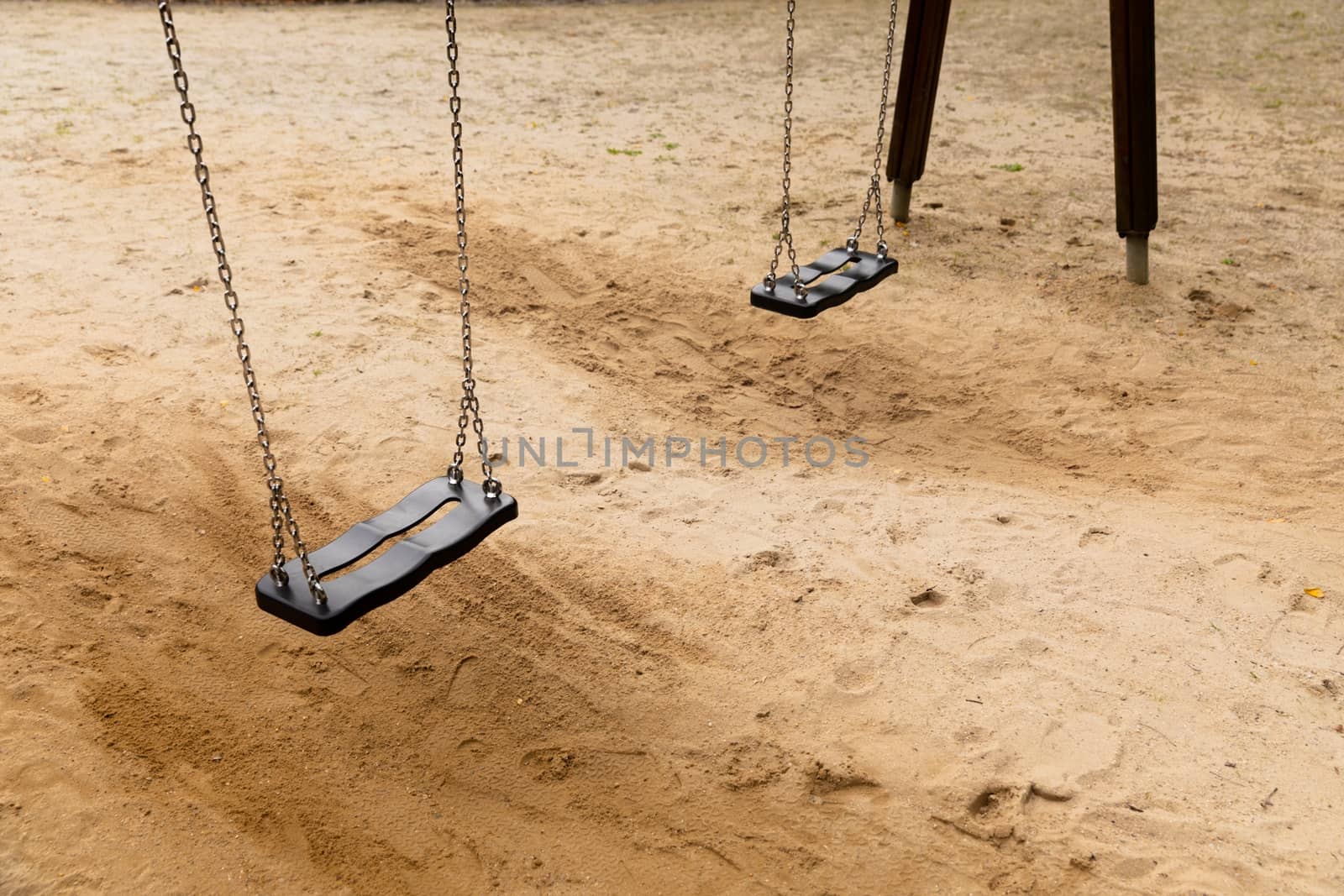 Some swings in the schoolyard close up photo