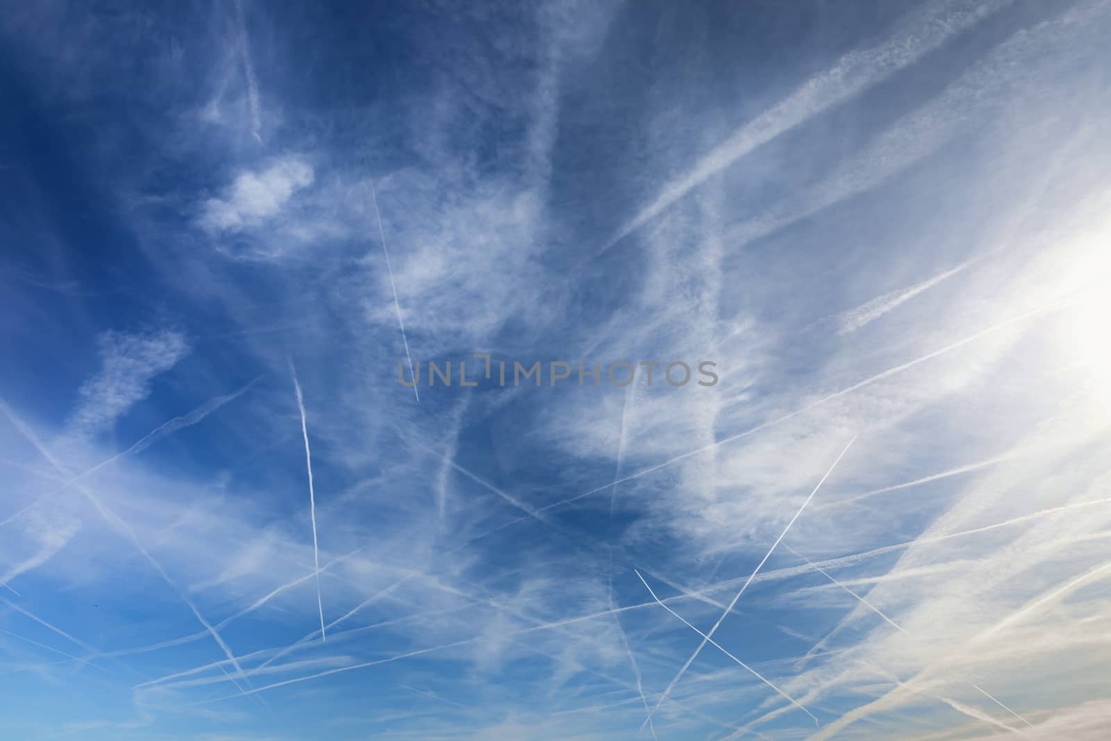 Contrails over blue sky closeup photo