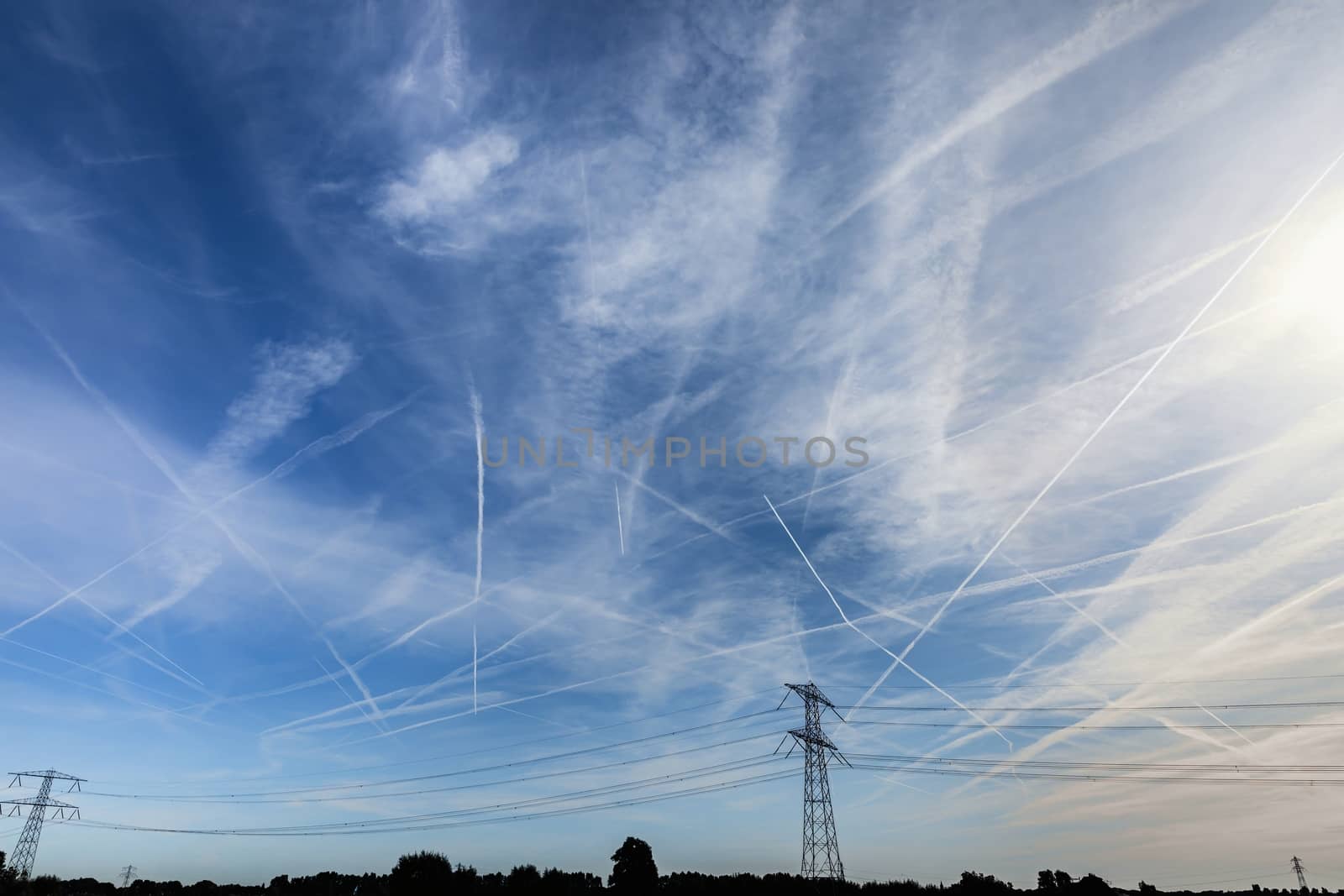 Contrails over blue sky closeup photo