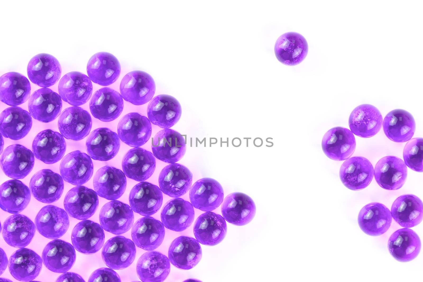 proton purple spherical ball capsules with selective focus isolated on white background.