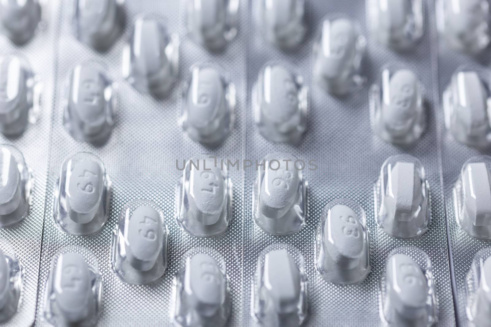 white tablets in blister closeup with selective focus.