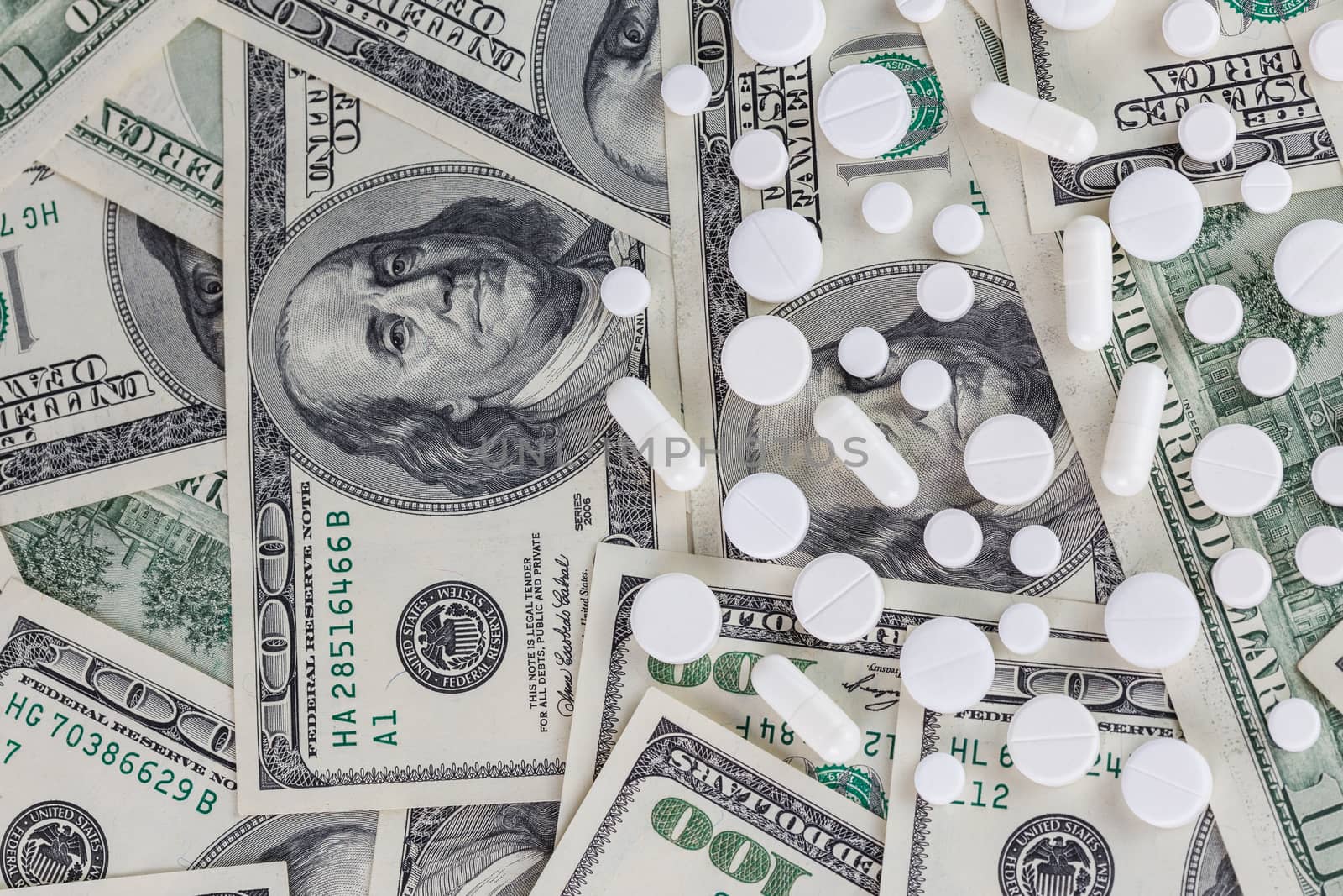 pills flat background, tablets on a us dollar banknotes - top-down view.