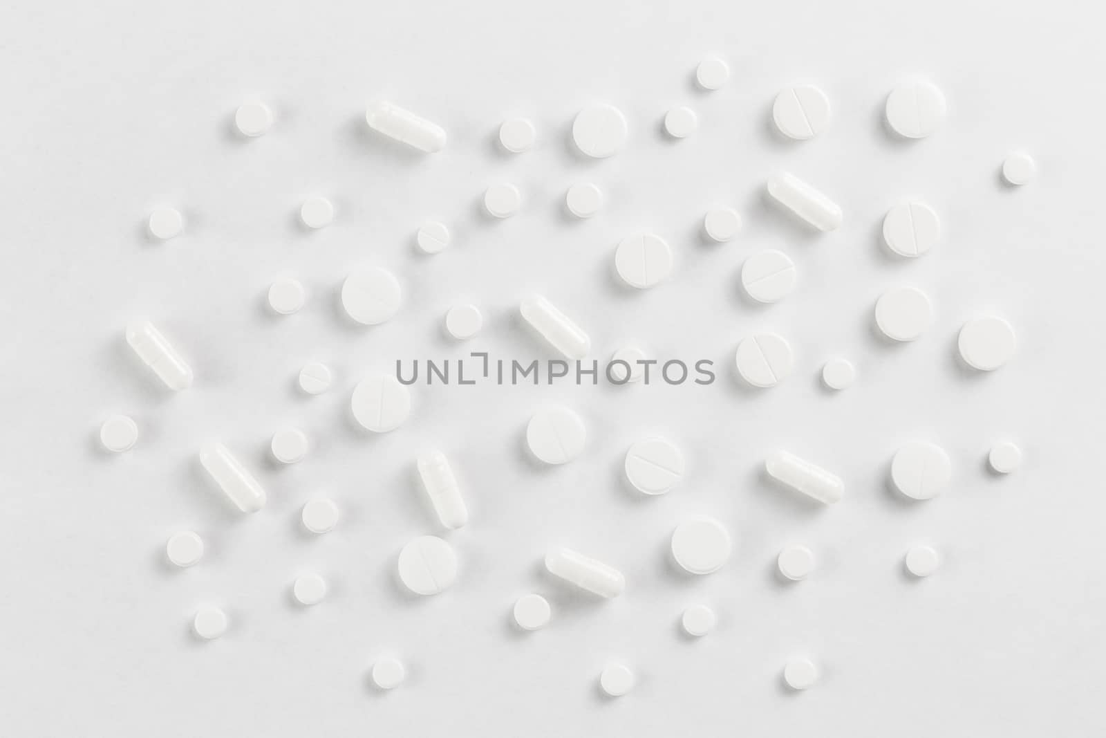 pills flat background, tablets spreaded on a white - top-down view.