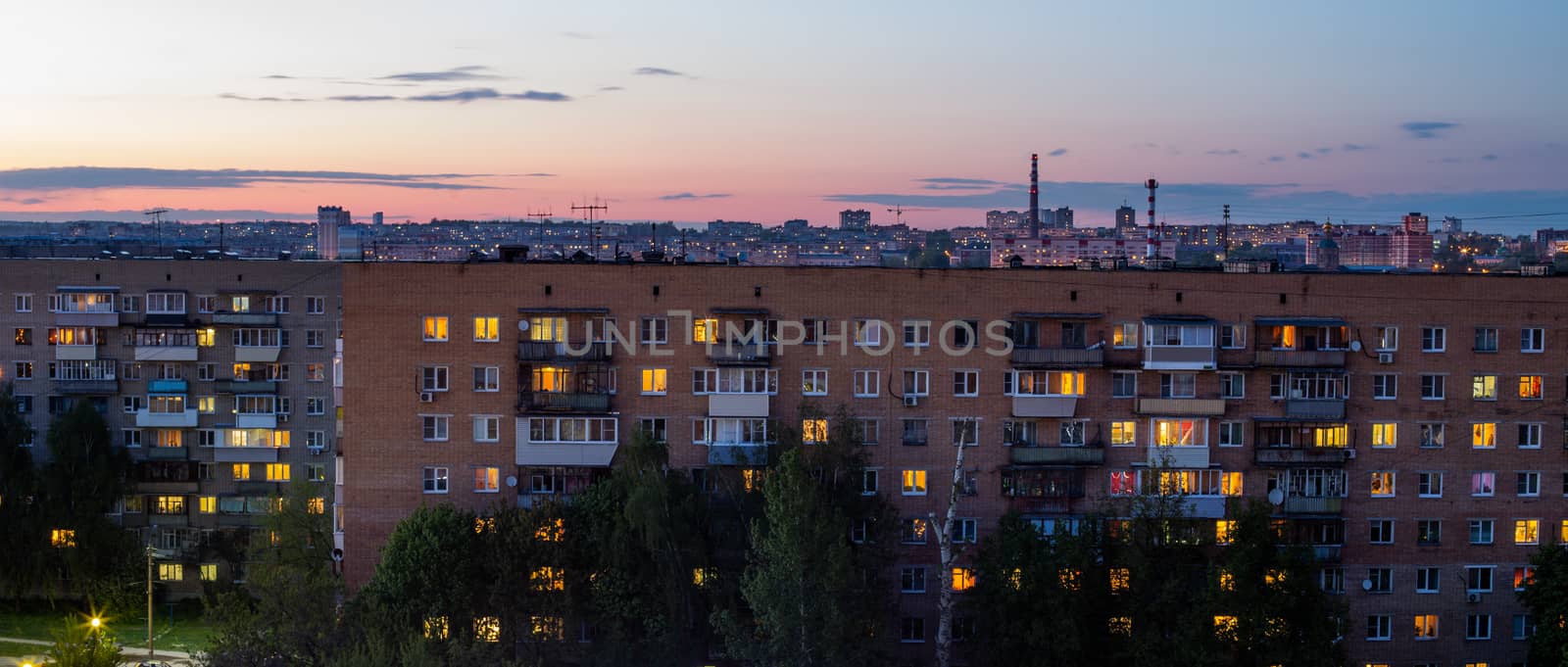 Windows, roofs and facade of an mass brick apartment building in Eastern Europe. Panoramic shot. by z1b