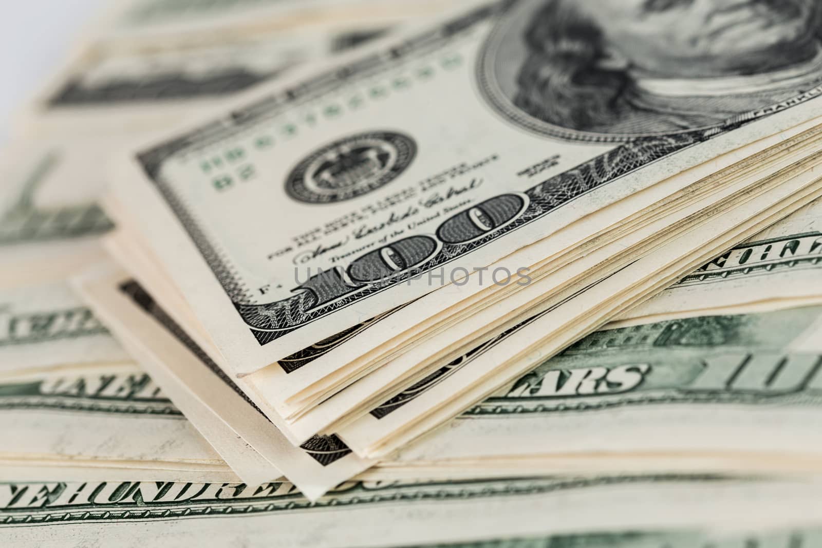 united states of america old dollar banknotes close-up background with selective focus - small stack over other