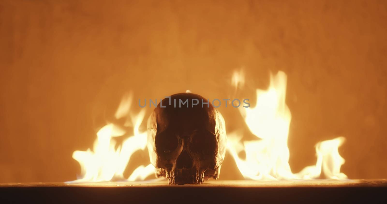 Burning human skull close up photo