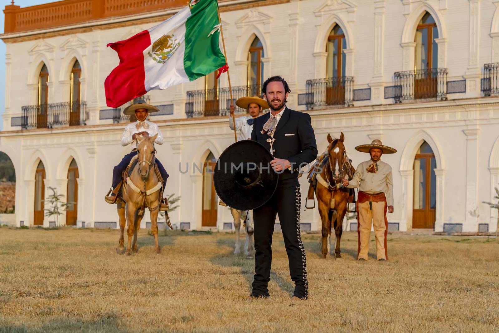 A Very Handsome Mexican Charro Poses In Front Of A Hacienda In The Mexican Countryside by actionsports