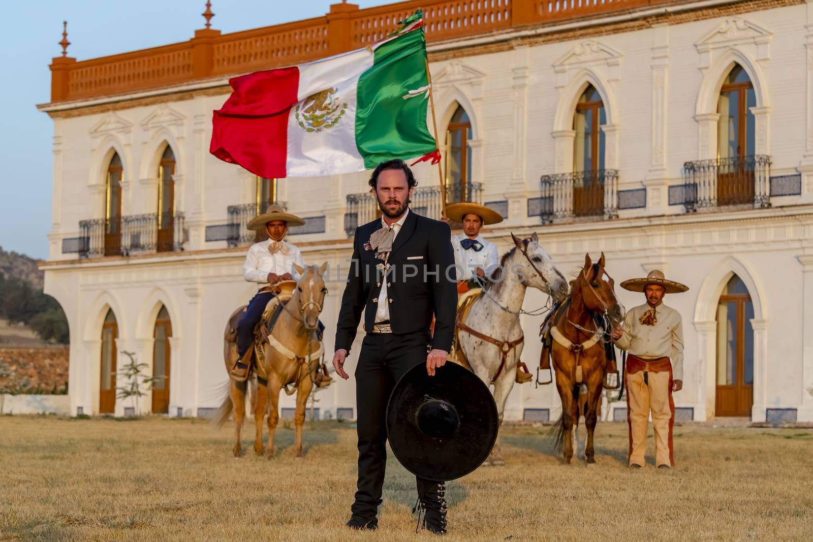 A Very Handsome Mexican Charro Poses In Front Of A Hacienda In The Mexican Countryside by actionsports