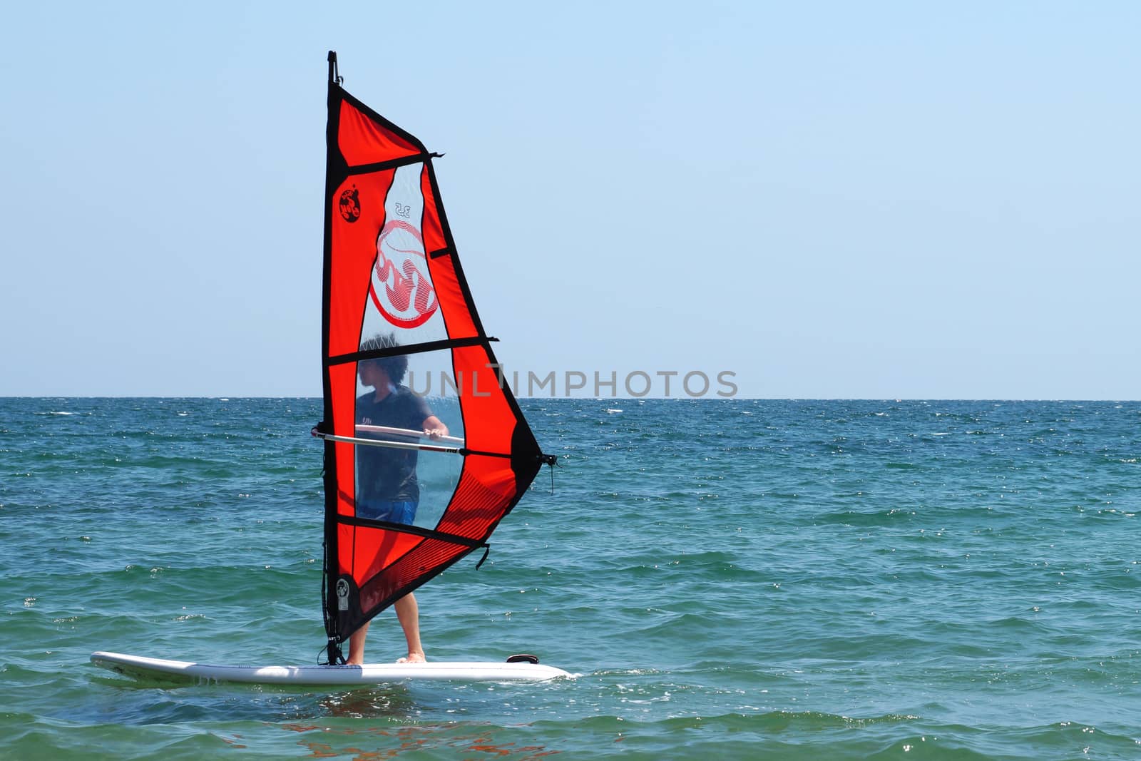 Varna, Bulgaria - July, 31,2020: young guy windsurfing in the sea