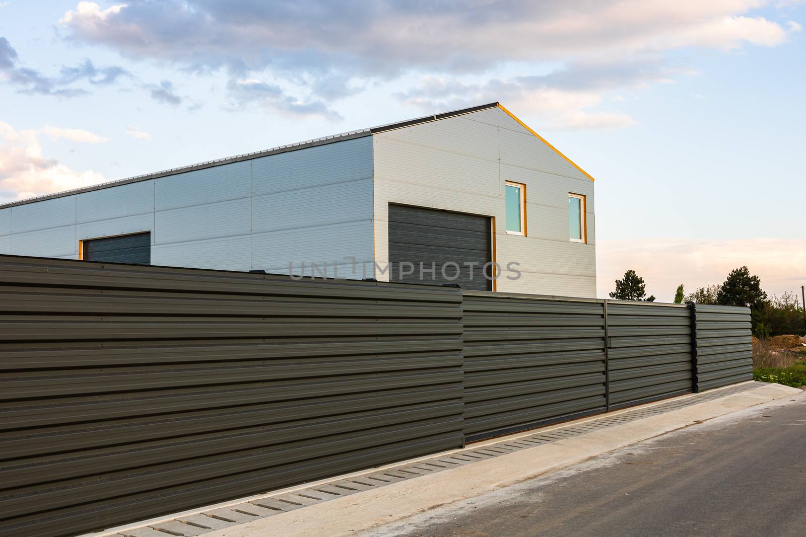 Big metal industrial storage shed building.  Exterior of warehouse, no brands on storehouse with copy space.