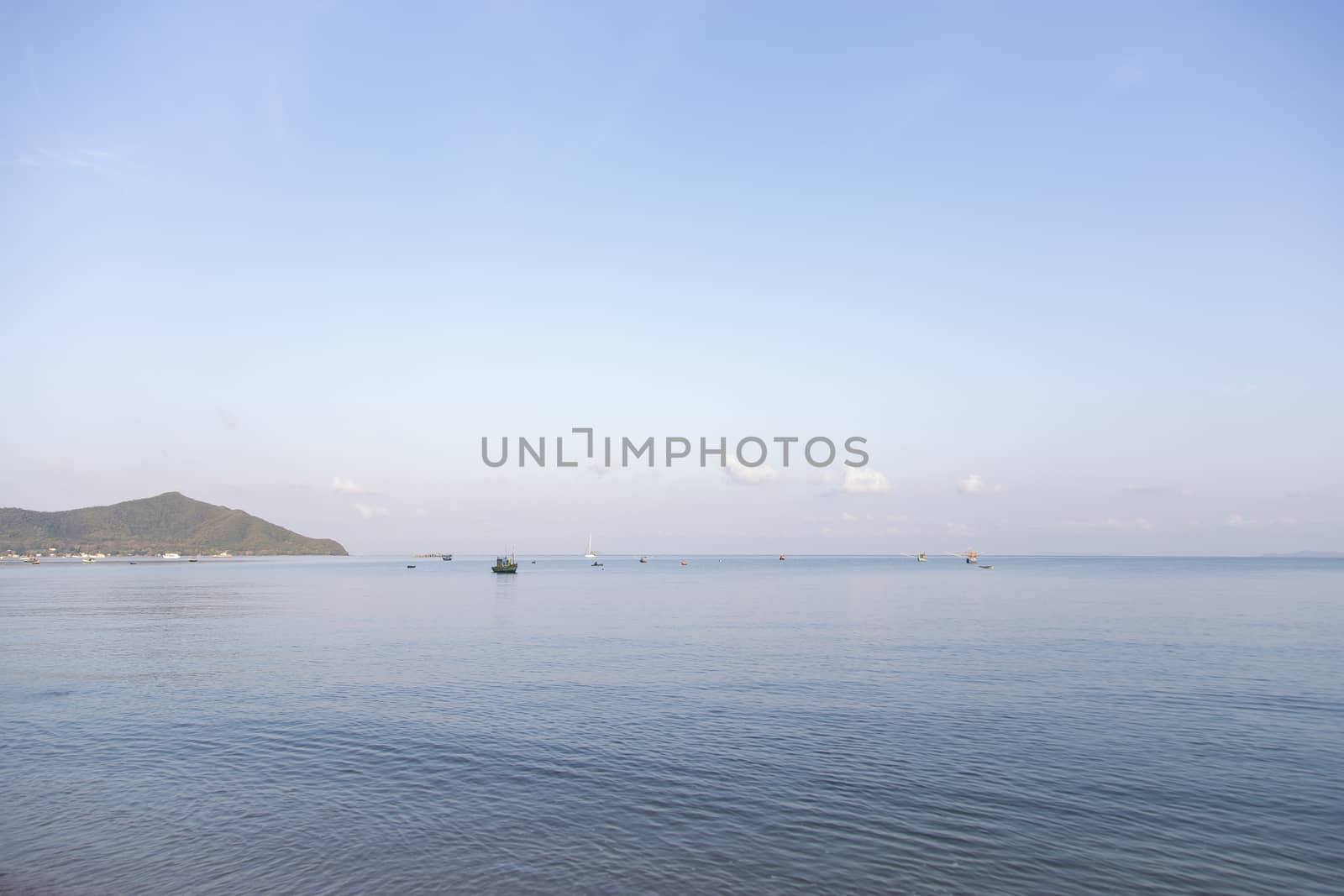 Sea with fishing boats and blue sky