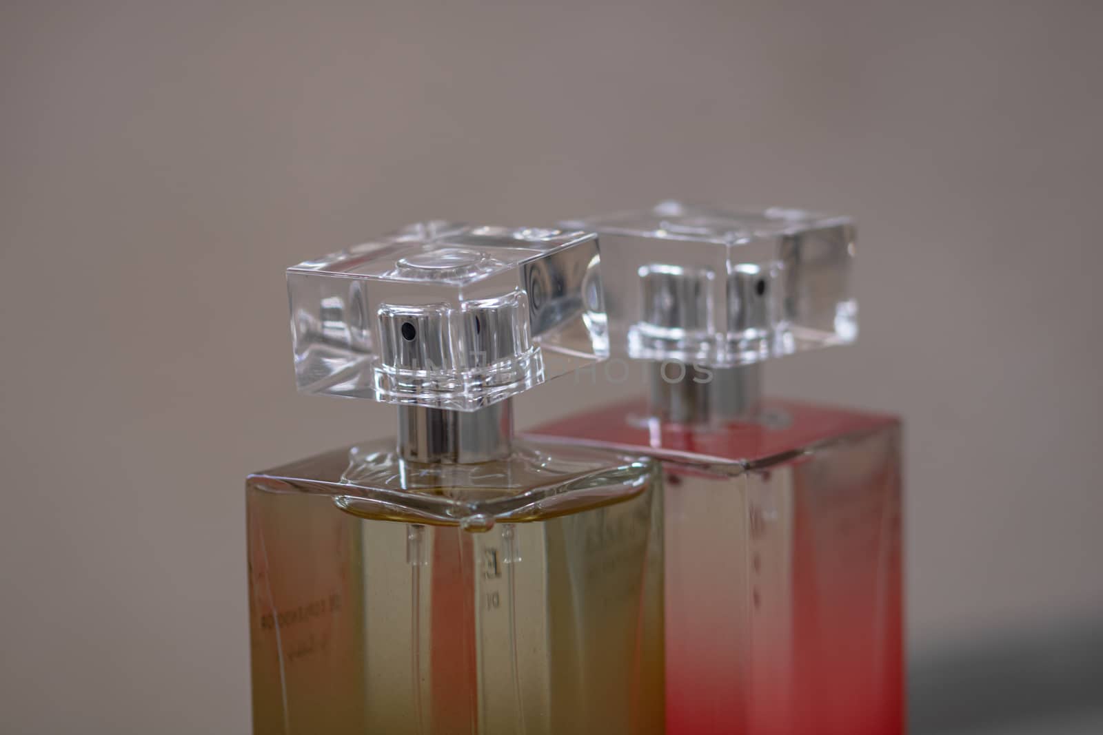 Elegant perfume bottle isolated on blurred background with copy space.