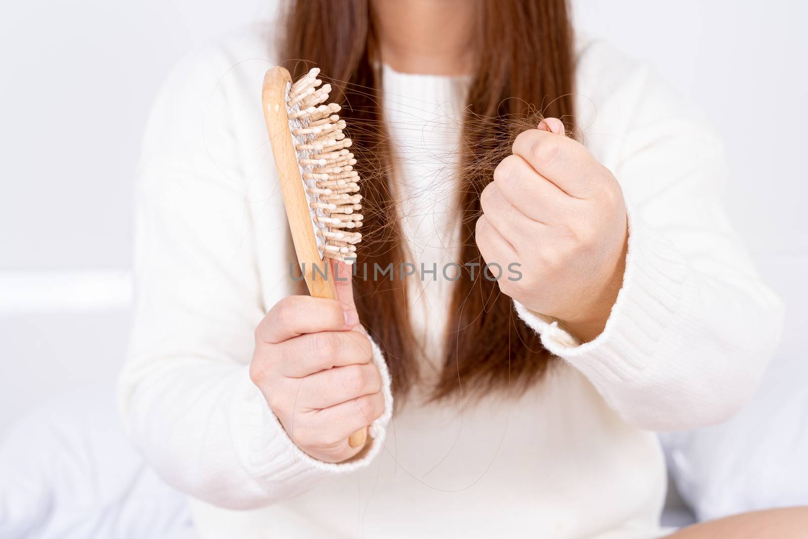 Hair fall problem, closeup hand holding comb and problem hair. Healthcare medical or daily life concept.