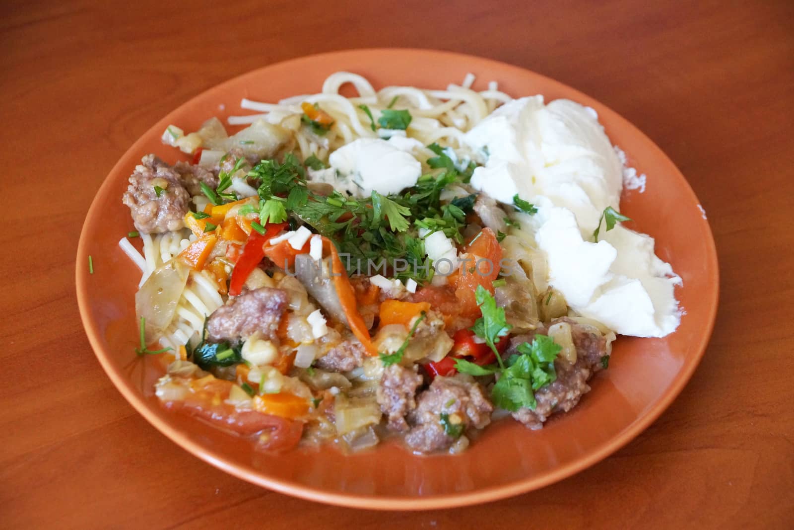 vegetable stew with meat and sour cream in a plate by Annado