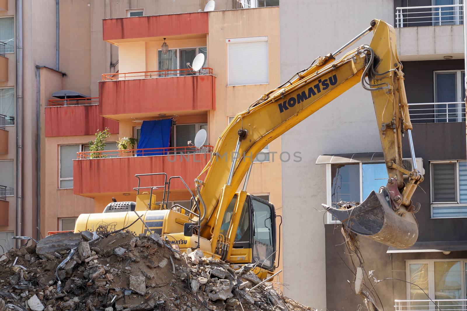 excavator demolishes a house in a residential area of Varna by Annado