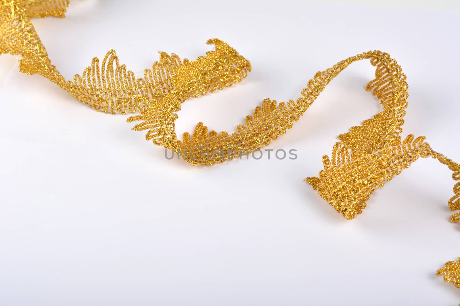 Braid lace made Luxury Metallic golden cord on white background. decoration for carnival and dance clothes costumes. Christmas texture. banner for website