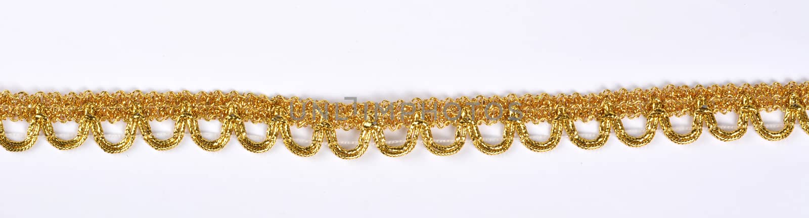 Braid lace made Luxury Metallic golden cord on white background. decoration for carnival and dance clothes costumes. Christmas texture. banner for website