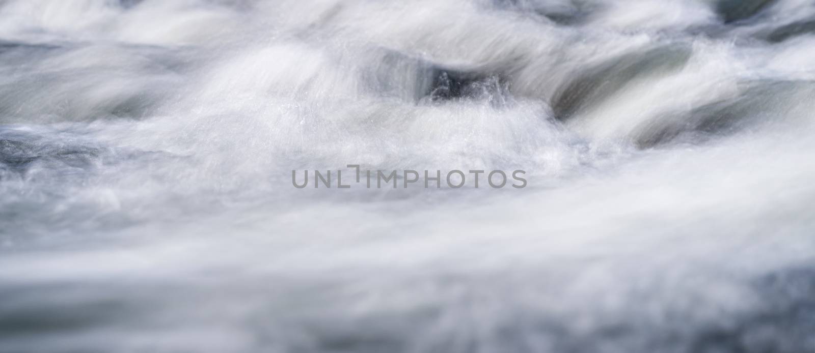 Long exposure photo - water flowing over rocks everything smooth, only few waterdrops in focus by Ivanko
