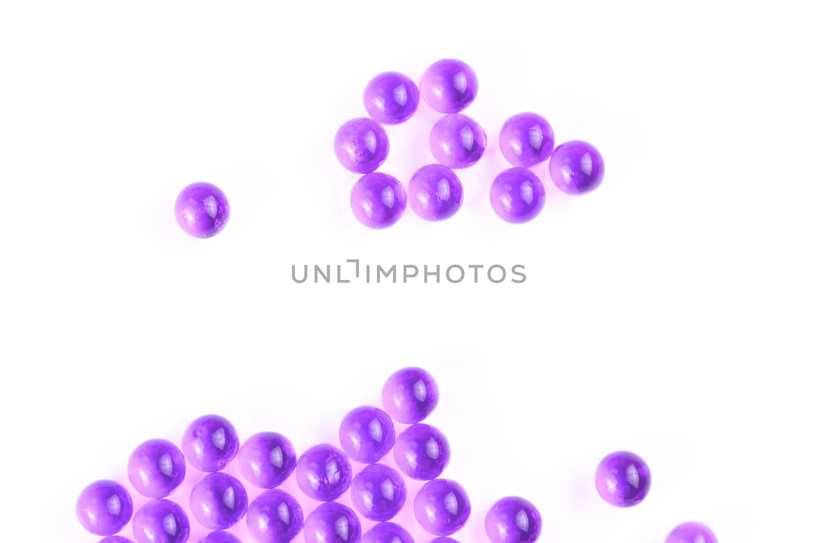 proton purple spherical ball capsules with selective focus isolated on white background.