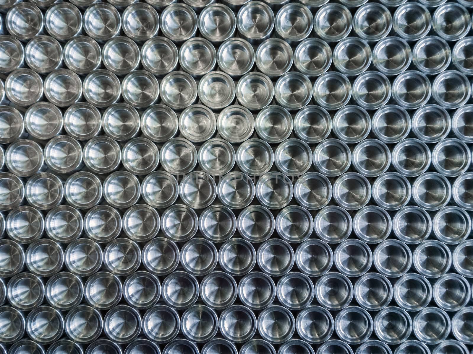 Shiny metal parts after cnc turning, on flat surface top-down flat lay background.