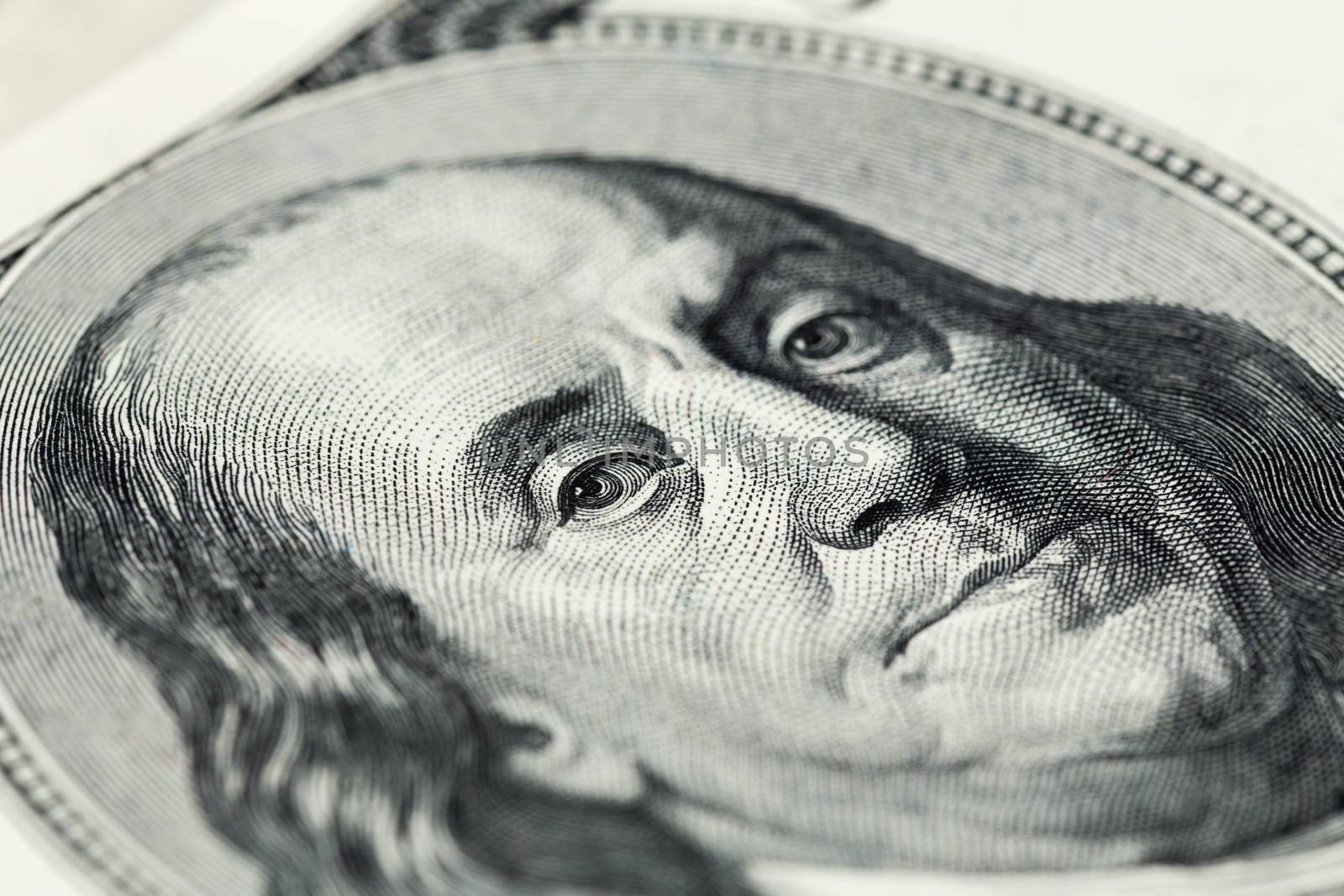 A close view of engraving portrait of Ben Franklin of old one hundred us dollars banknote. Selective focus with natural lens blur.