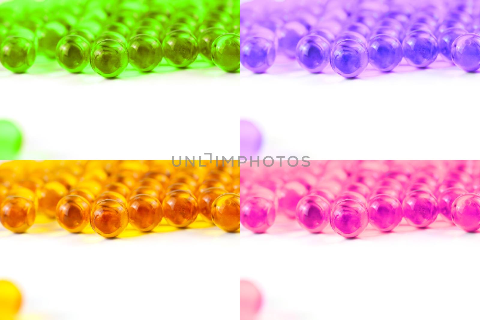 set of colored spherical ball capsules of fish oil selective focus isolated on white background.