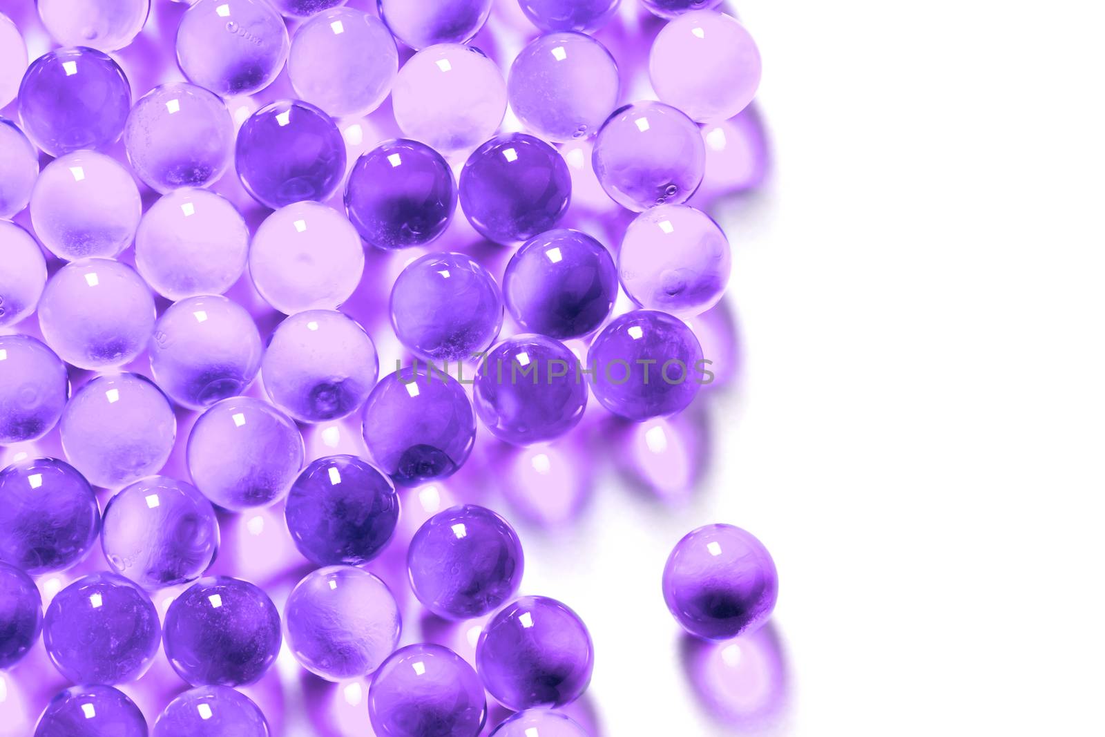 proton purple spherical ball capsules with selective focus isolated on white background.